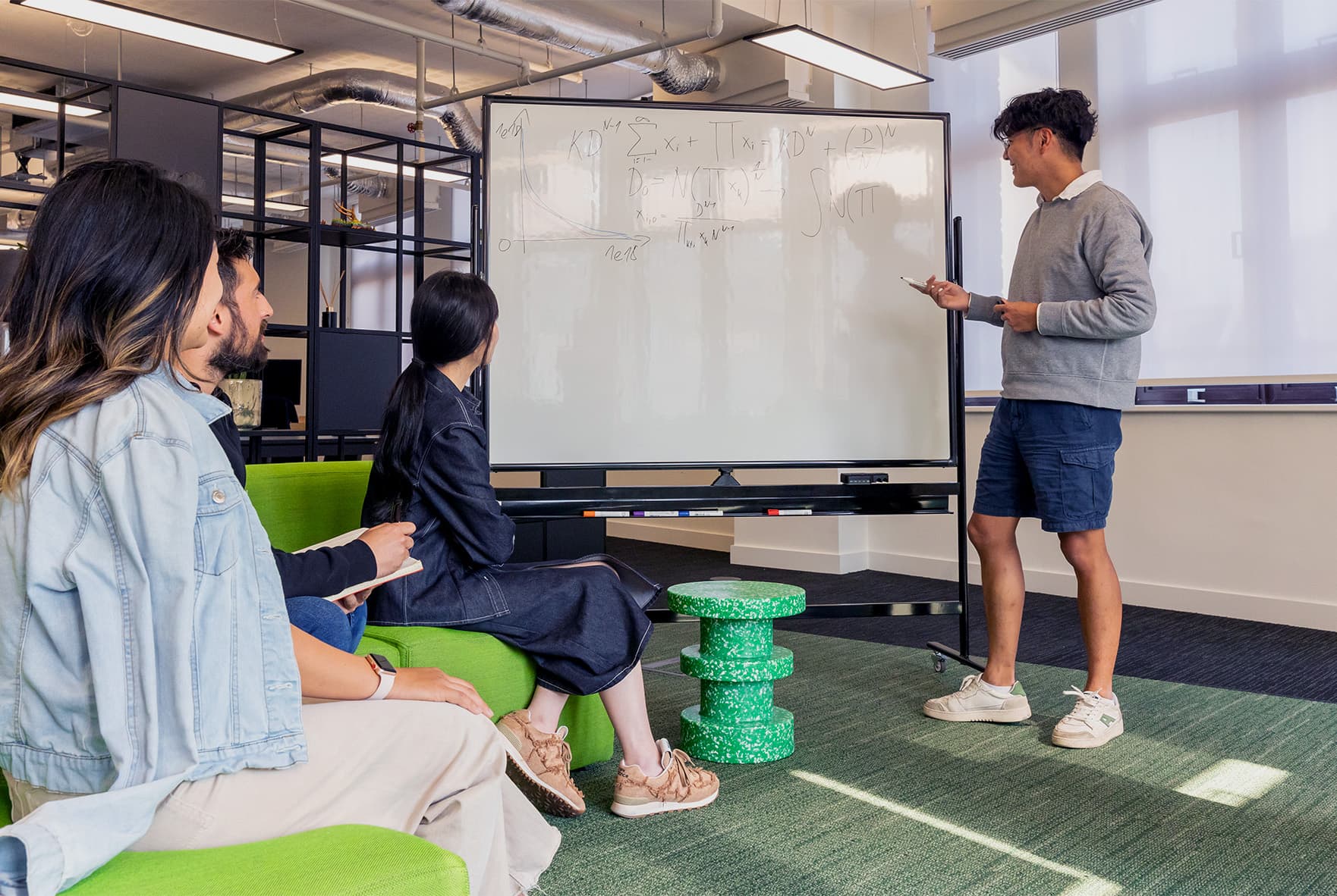 Team members collaborating near trading screens