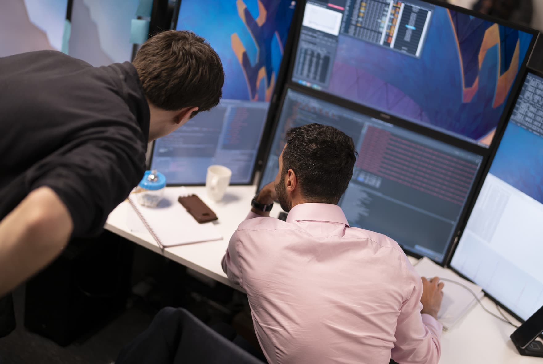 Technology team working at monitors